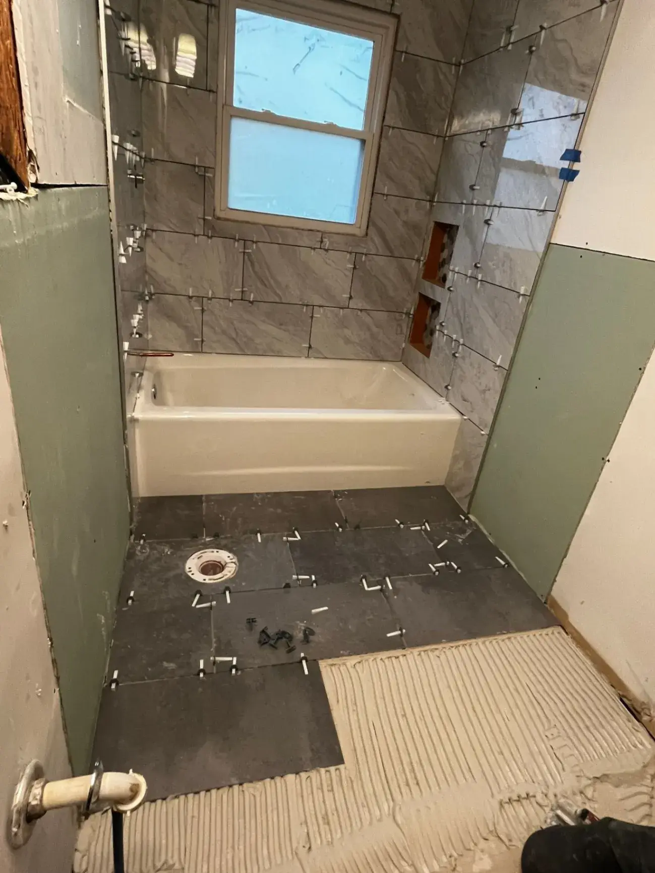 Bathroom during tile work with backer board and thinset on the floor