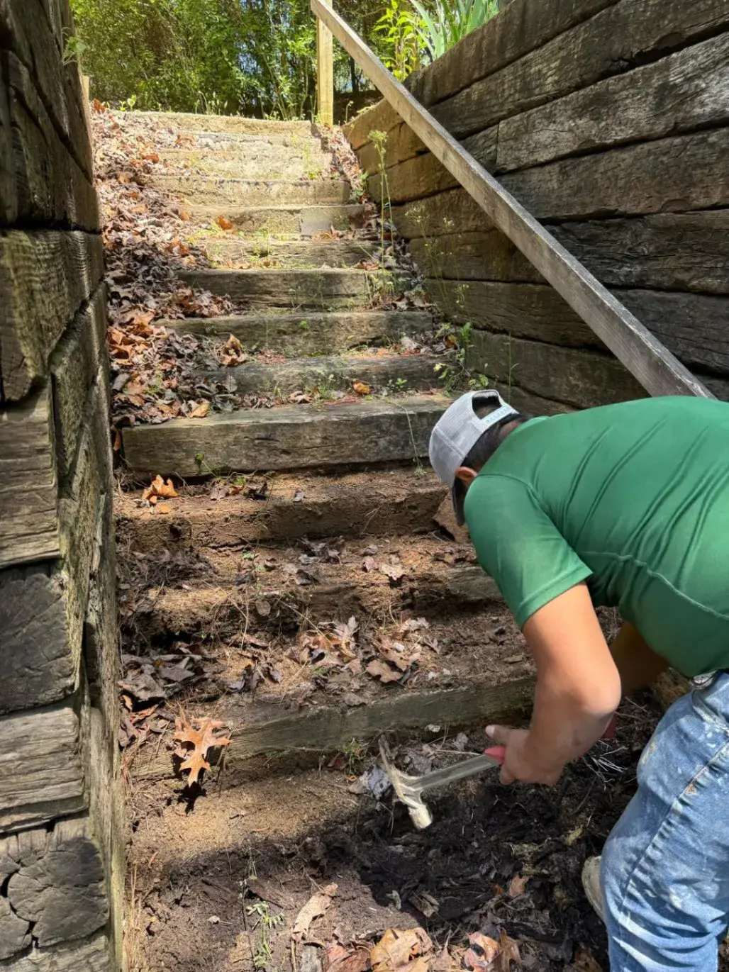 Crew member clearing the old hillside path