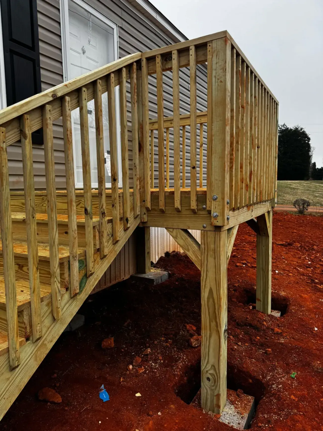 Close view of deck stairs, posts and bolted framing