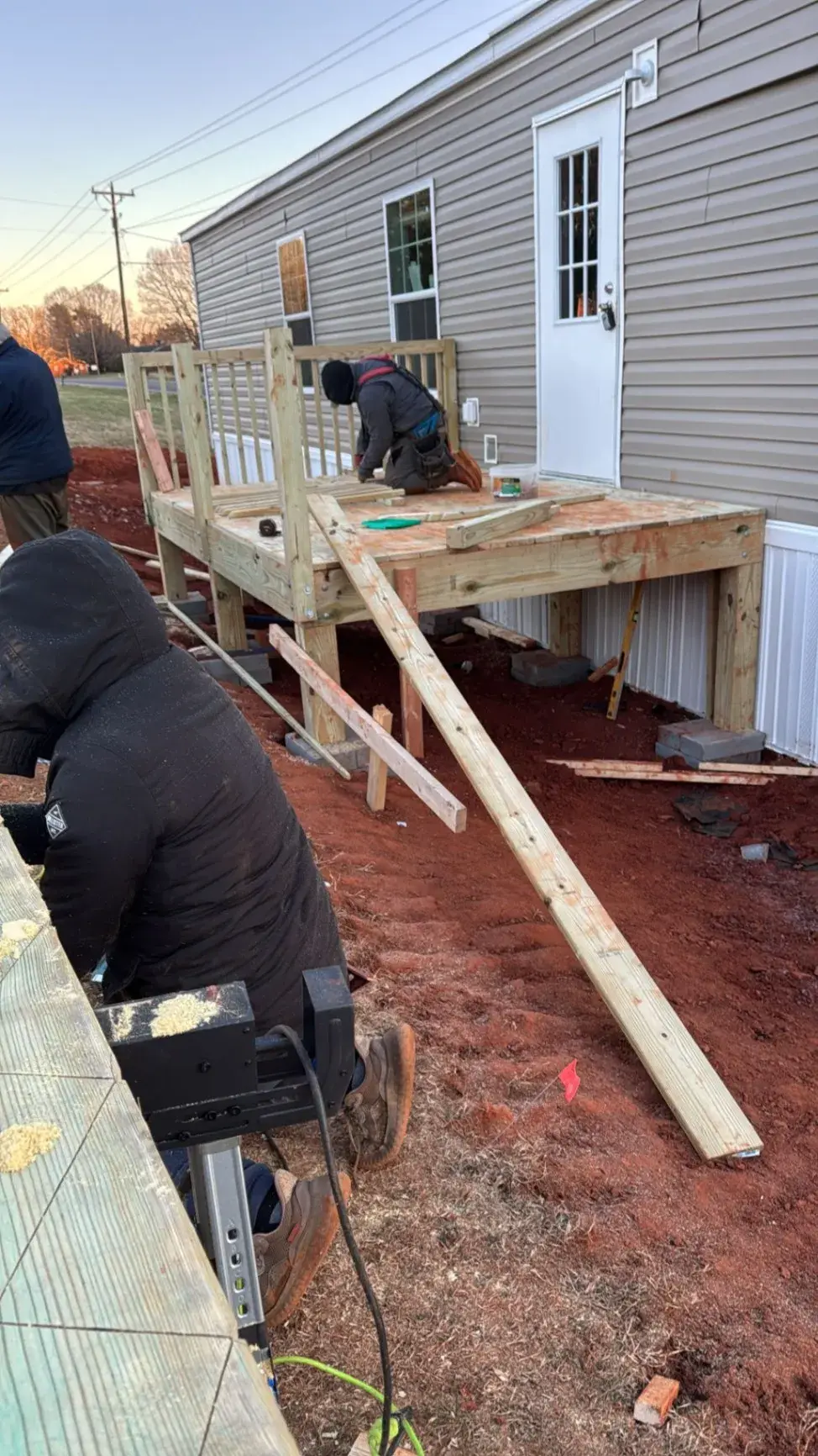 Crew building a deck and cutting stringers on site