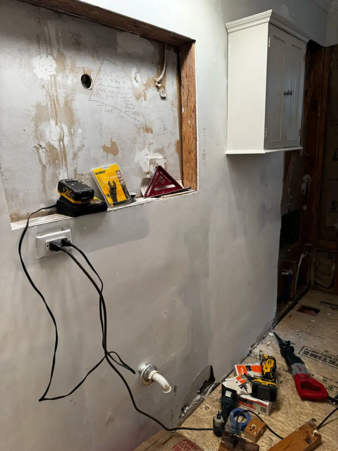 Kitchen wall opened up with outlets and plumbing roughed in during a remodel