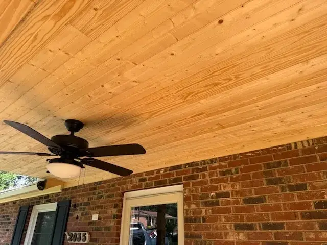 Tongue-and-groove pine porch ceiling with a ceiling fan