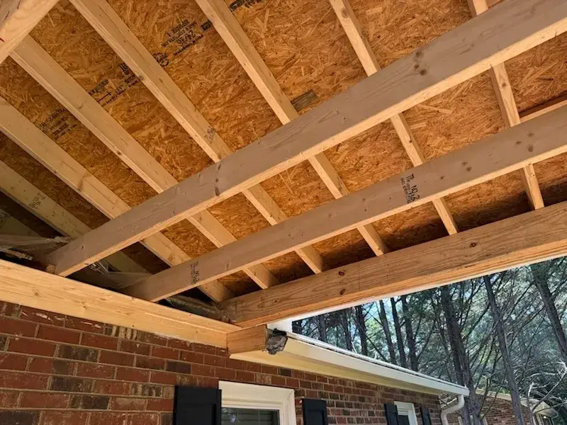 Porch roof framing tied into a brick home