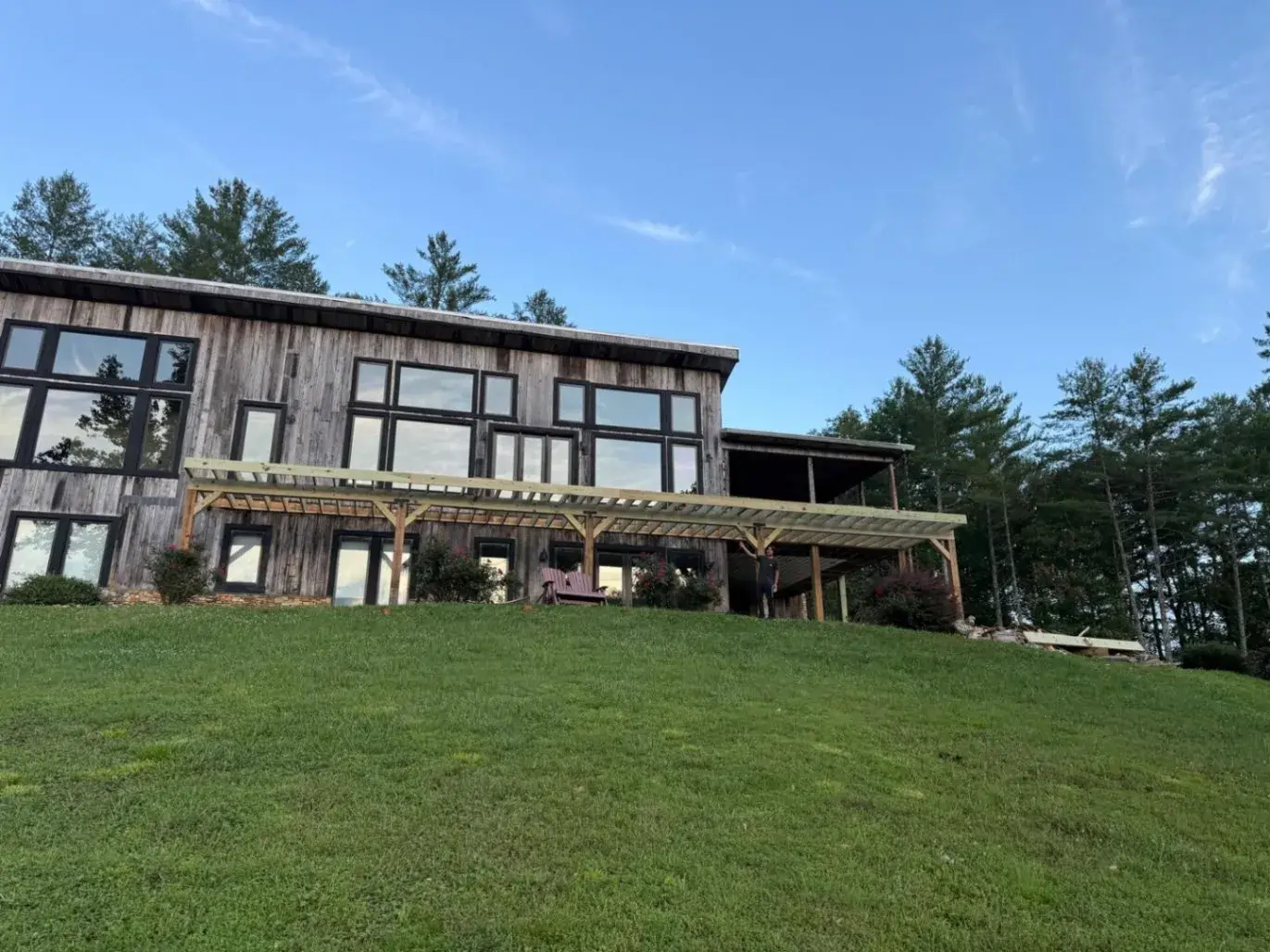 Mountain home with wood siding and a long covered porch