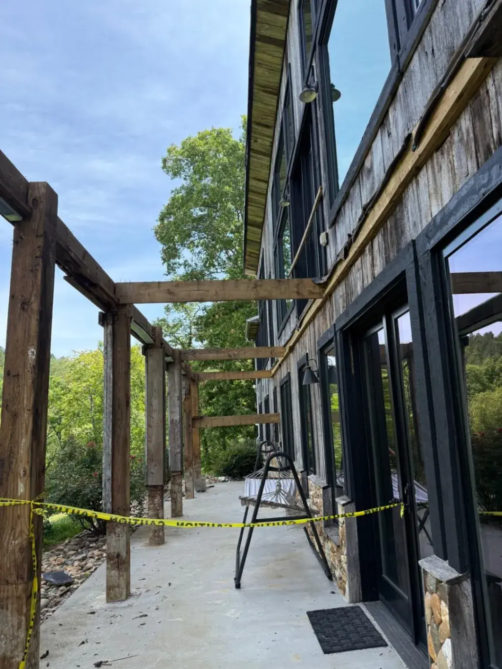 Timber porch posts along a mountain home during work
