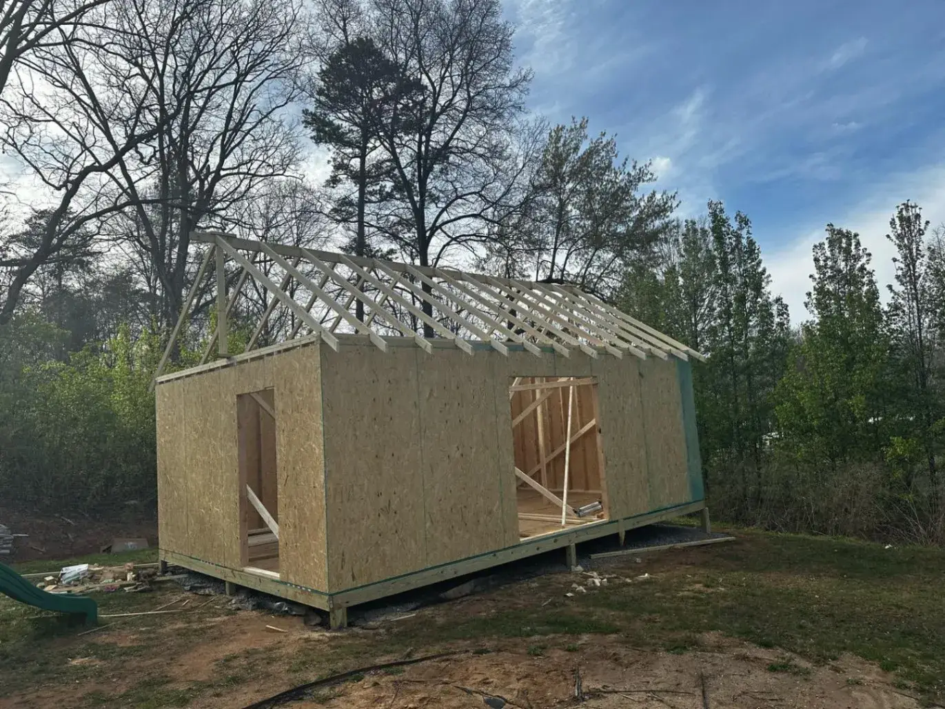 Sheathed building with roof trusses set in place