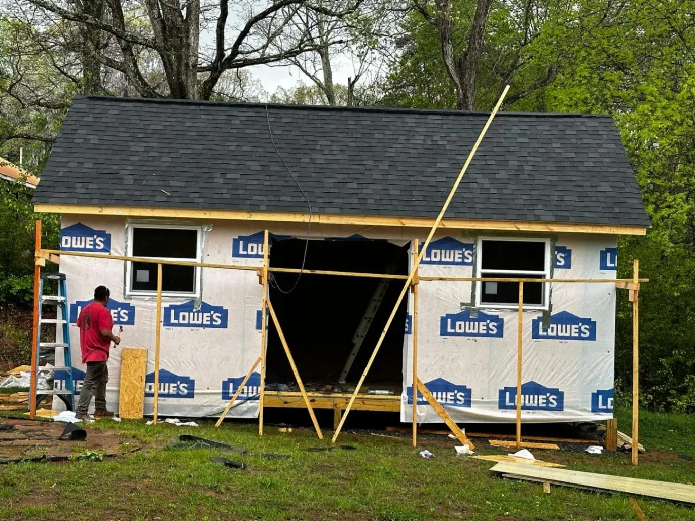 Shed walls wrapped in house wrap under a finished roof