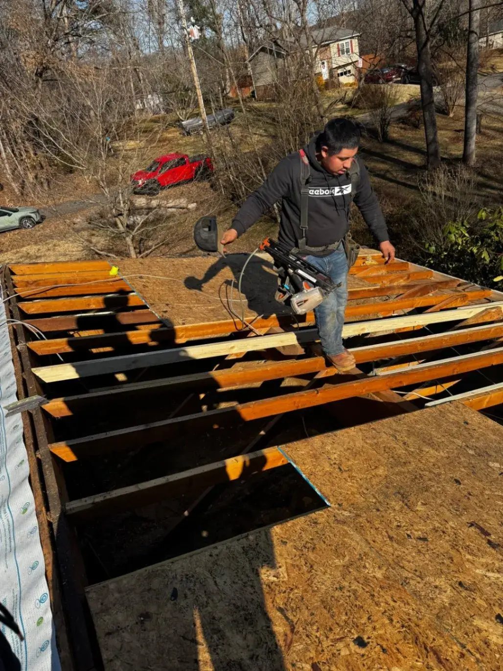 Roofer walking across a roof during tear-off