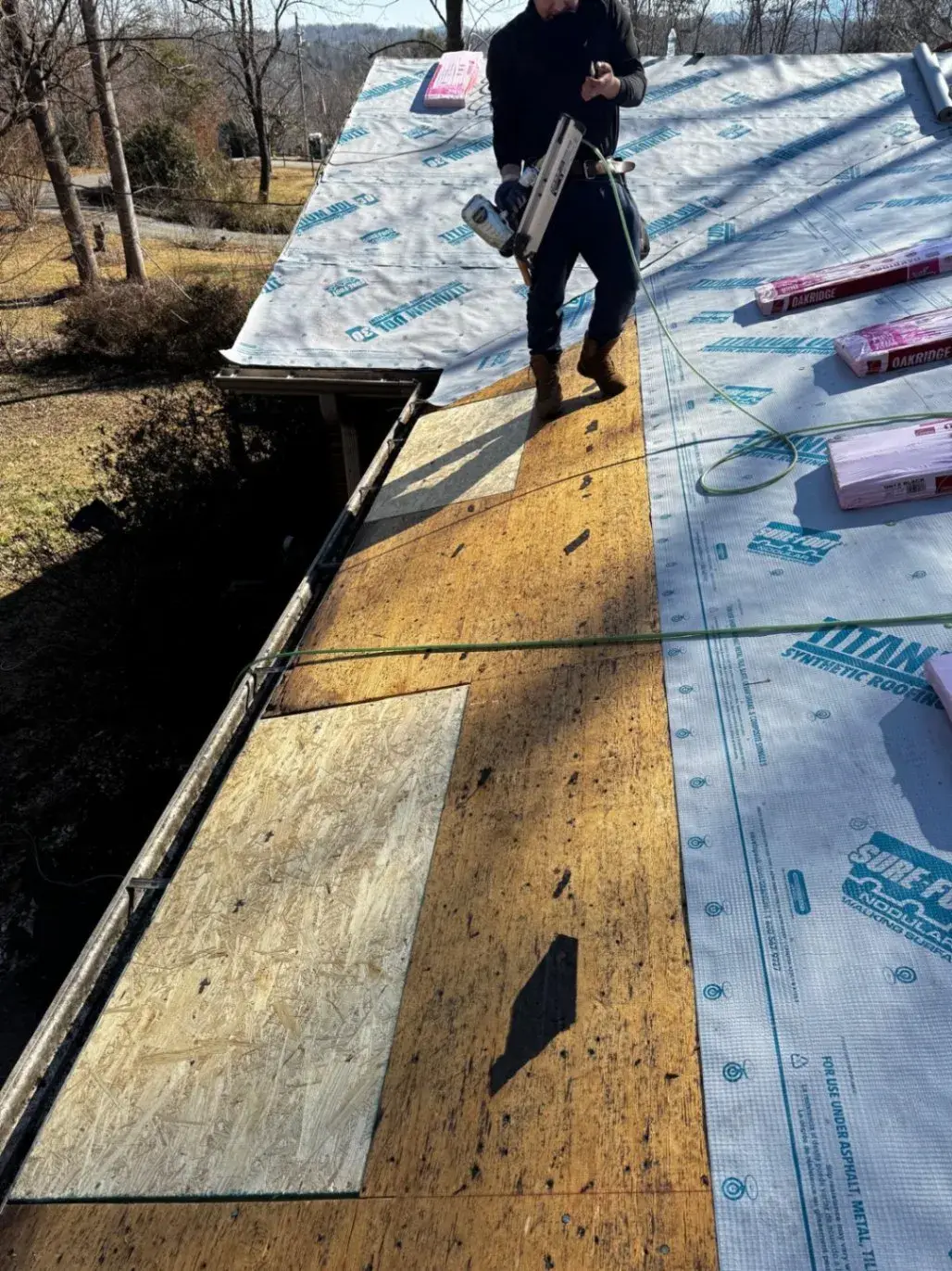 New decking and underlayment along the roof edge